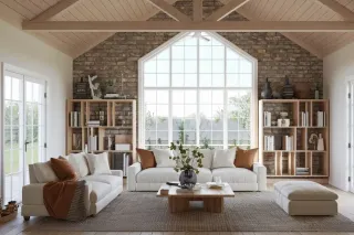 Salon lumineux avec une grande fenêtre, des canapés blancs, et des étagères en bois sur fond de mur en briques.